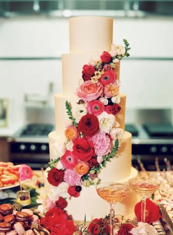 a fantastic plain five tier wedding cake with bold red, burgundy, pink and neutral blooms is a beautiful statement to make