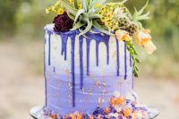 61 a gorgeous ombre violet wedding cake with violet drip, with bold florals and greenery on top and a bit of colored sugar is fun and cool