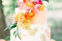 63 a gorgeous summer wedding cake with white and peachy tiers, with gold and croal brushstrokes, with yellow and pink blooms and a greenery branch is a fantastic statement