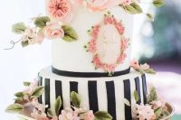 79 a pretty spring or summer wedding cake with a black and white vertical stripe tier and a white one with floral decor, with pink sugar and fresh blooms