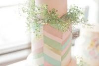 81 a quirky wedding cake in blush with colorful chevron detailing and lots of greenery for a bright spring or summer wedding