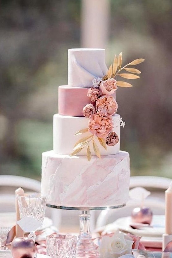 a romantic wedding cake with a white, pink and pink marble tier, dried blooms and gold foliage is a very romantic option