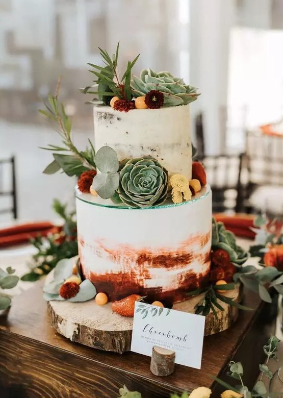 a watercolor burgundy semi naked wedding cake decorated with bold blooms, greenery and succulents for a bright summer or fall wedding