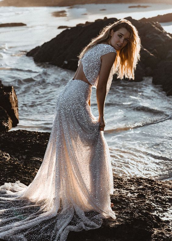 a beach bridal separate with a sleeveless crop top with an open back and an A line skirt with a train