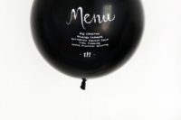 a black balloon with white letters is a creative and fun modern idea for a fresh and modern feel