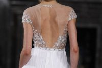 a breathtaking A-line wedding dress with an embellished bodice and cap sleeves, a pleated skirt and an illusion cutout embellished back