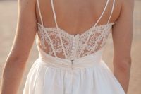 a charming A-line wedding dress with a lace detail and buttons plus straps on the back, pleated full skirt is a lovely idea
