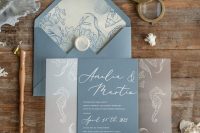 a chic beach wedding invitation suite in blue and grey with sea creature prints is lovely and relaxed