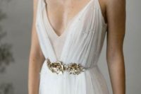 a delicate pleated wedding dress on spaghetti straps, with a double bodice, pearls and a gold floral belt