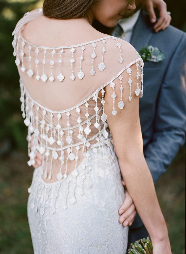 a fabulous boho fitting wedding dress of lace, with an illusion back with rows of lace appliques hanging down is a jaw-dropping idea