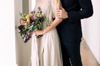 a flowy dove grey wraped Grecian wedding dress with a V-neckline and a cold shoulder is very romantic