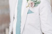 a fresh summer wedding outfit with an off-white suit, a mint blue tie and a pale floral boutonniere