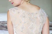 a glam fitting wedding dress with an illusion back detailed with rhinestones forming a geometric pattern is a stunning solution