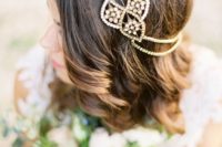 a gold and crystal boho chic bridal headpiece with two layers looks very bold and romantic