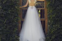 a gorgeous A-line wedding dress of leaf appliques, a tulle A-line skirt with a train and an illusion back with leaf appliques is wow