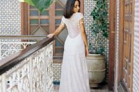 a jaw-dropping A-line boho lace wedding dress with an illusion back with hanging lace pieces is a gorgeous idea for a Moroccan wedding
