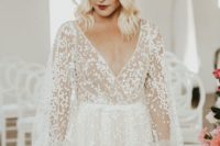 a lace A-line wedding dress with puff sleeves, a deep V-neckline is a modern romantic piece for a bride