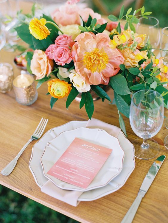 a lovely summer wedding centerpiece of blush, pink and yellow blooms and foliage is amazing and chic