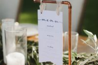 a modern wedding menu hanging on copper is a stylish idea for a modern or boho wedding