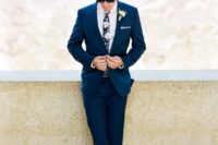 a navy suit, a moody floral tie and brown shoes for an ultimate groom’s look with trends incorporated