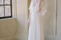 a neutral flowy A-line wedding dress with a V-neckline, wide flowy sleeves and a train
