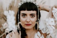 a silver and rhinestone bridal crown with hanging crystals is a very boho chic idea