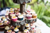 a tiered wedding cake stand of wood slices and a stick is a stylish idea for a rustic or a woodland wedding