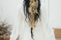 a whimsical boho chic headpiece of dried herbs and large feathers is a cool idea for a wild free-spirited bride