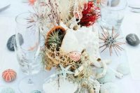 bright beach wedding table decor with air plants, urchins, seashells, blooms, corals and herbs is chic