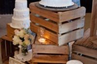 crates with simple cake stands, candles and blooms in a vase will work nice for a rustic wedding