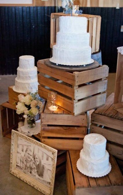 crates with simple cake stands, candles and blooms in a vase will work nice for a rustic wedding