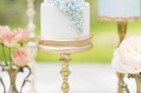 elegant gilded gold cake stands make the ruffled and hydrangea wedding cakes more refined