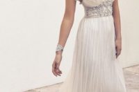 flowing Grecian wedding dress with embellished straps and bodice plus shoulder accessories and a deep neckline
