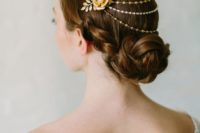 gold and silver chain and crystal bridal headpiece with a faux flower with a pearl plus fabric leaves looks veyr elegant