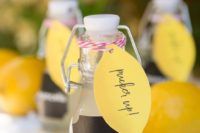 mini bottles with limoncello with colorful tags are a cute idea for a summer or Italian wedding