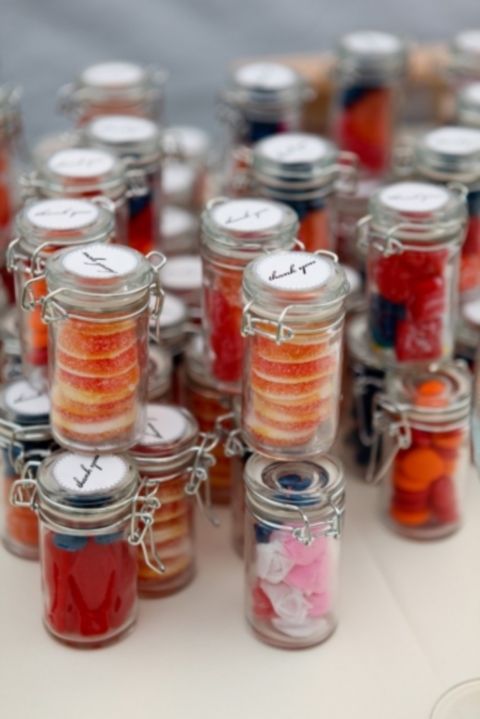 mini jars with tasty sweets in bold colors for a cool summer wedding   perfect and very budget friendly