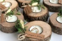 wood slice candle holders with tealights, greenery, tags are nice for a summer wedding, camp, woodland or rustic