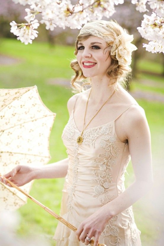 a 20s inspired headband with an oversized fabric floral and feathers in tan and neutrals is a chic idea