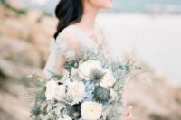 a beautiful coastal wedding bouquet of white, powder blue, pale leaves and twigs