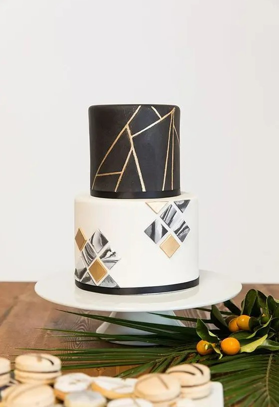 a black, white and gold wedding cake with geometric decor and 3D geometric tiles on the lower tier is a lovely idea to rock