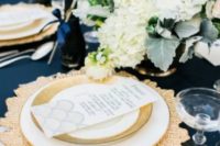 a chic navy, gold and creamy wedding tablescape with lush floral centerpieces