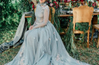 a gorgeous powder blue wedding dress with a high neckline, a train and floral appliques is wow