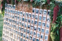 a gorgeous wedding seating chart of Polaroids, greenery, blooms and calligraphy