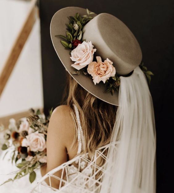 a grey bridal hat with fresh blooms and greenery and a veil is a lovely idea for a romantic bride