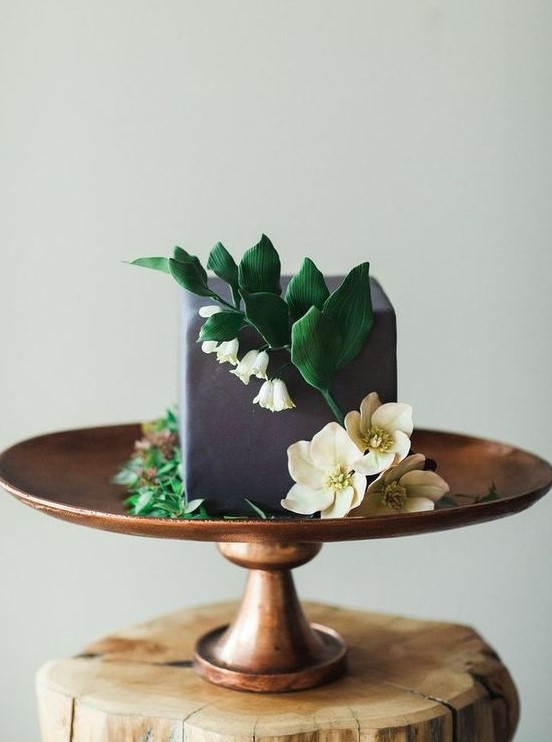 a grey square buttercream wedding cake decorated with sugar blooms and leaves is a catchy and unusual idea