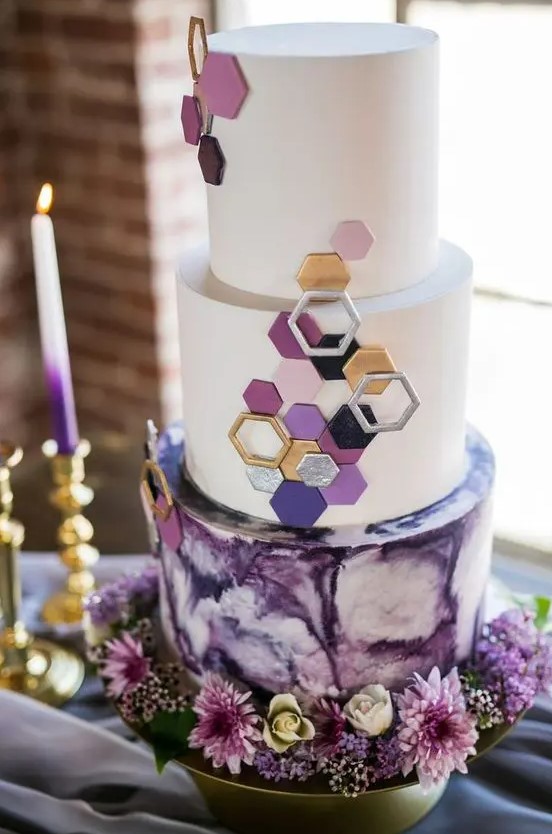 a jaw-dropping round wedding cake with a purple watercolor and white tiers, with 3D hexagons covering the tiers is just fantastic