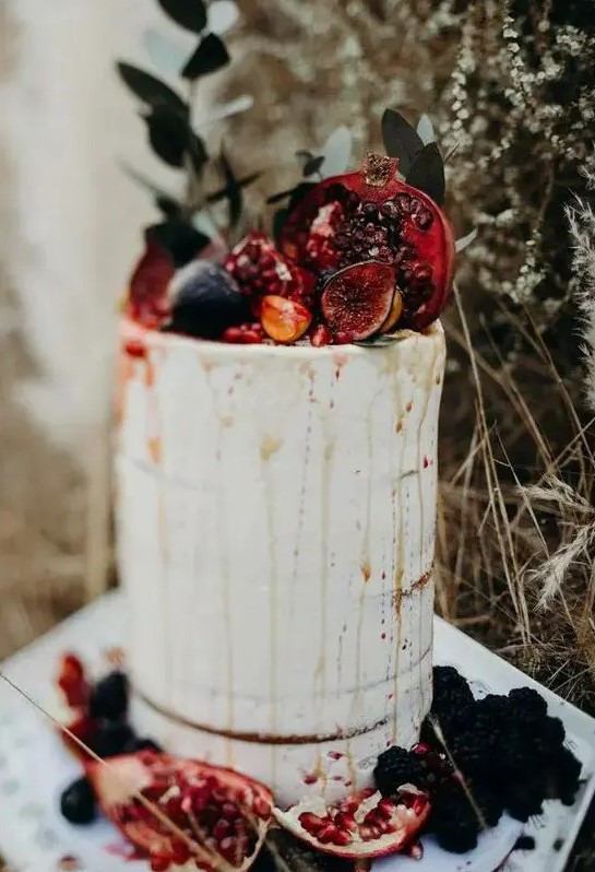 a naked fall wedding cake with drip, fresh figs and pomegranates is a lovely decadent idea for a fall celebration