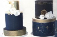 a navy, gold and creamy wedding dessert table with macarons and cakes