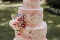 a pink marble wedding cake with gold foil, pink and blush blooms, some greenery is always a good idea for a spring or summer wedding