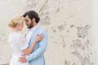 a powder blue groom’s suit and a white shirt for a coastal or beach look